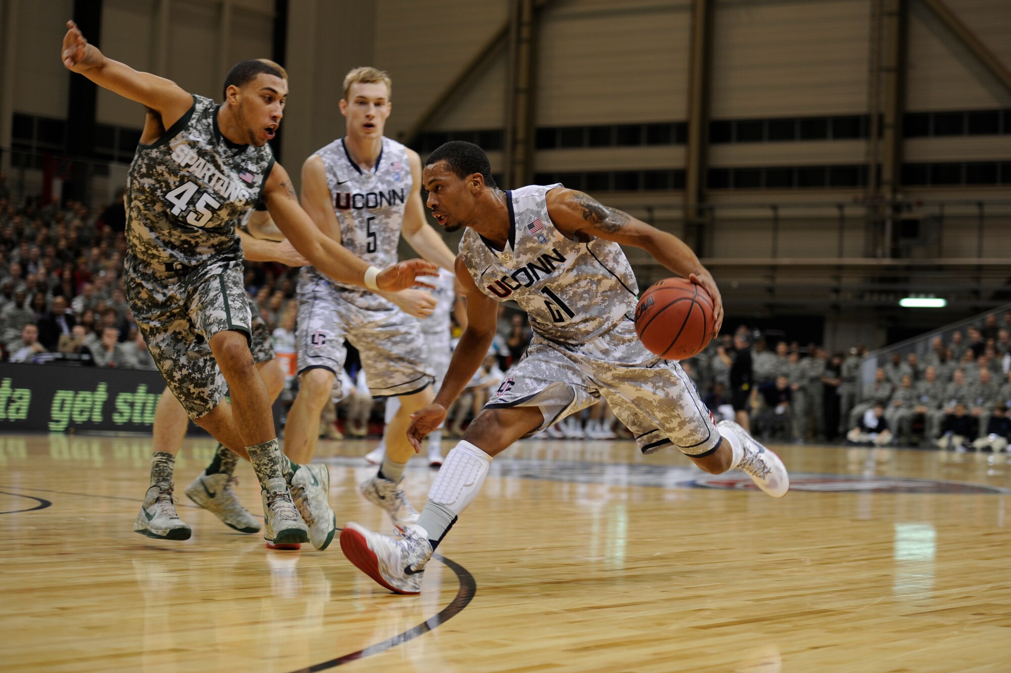Omar Calhoun, University of Connecticut point guard, sprints for the hoop during the 2012 Armed Forces Classic on Ramstein Air Base, Germany, Nov. 10, 2012. The match-up between Michigan State University and UCONN is part of ESPN's Veteran's week initiative to honor the men and women who have served and are still serving in the U.S. military. (U.S. Air Force photo/Senior Airman Aaron-Forrest Wainwright)