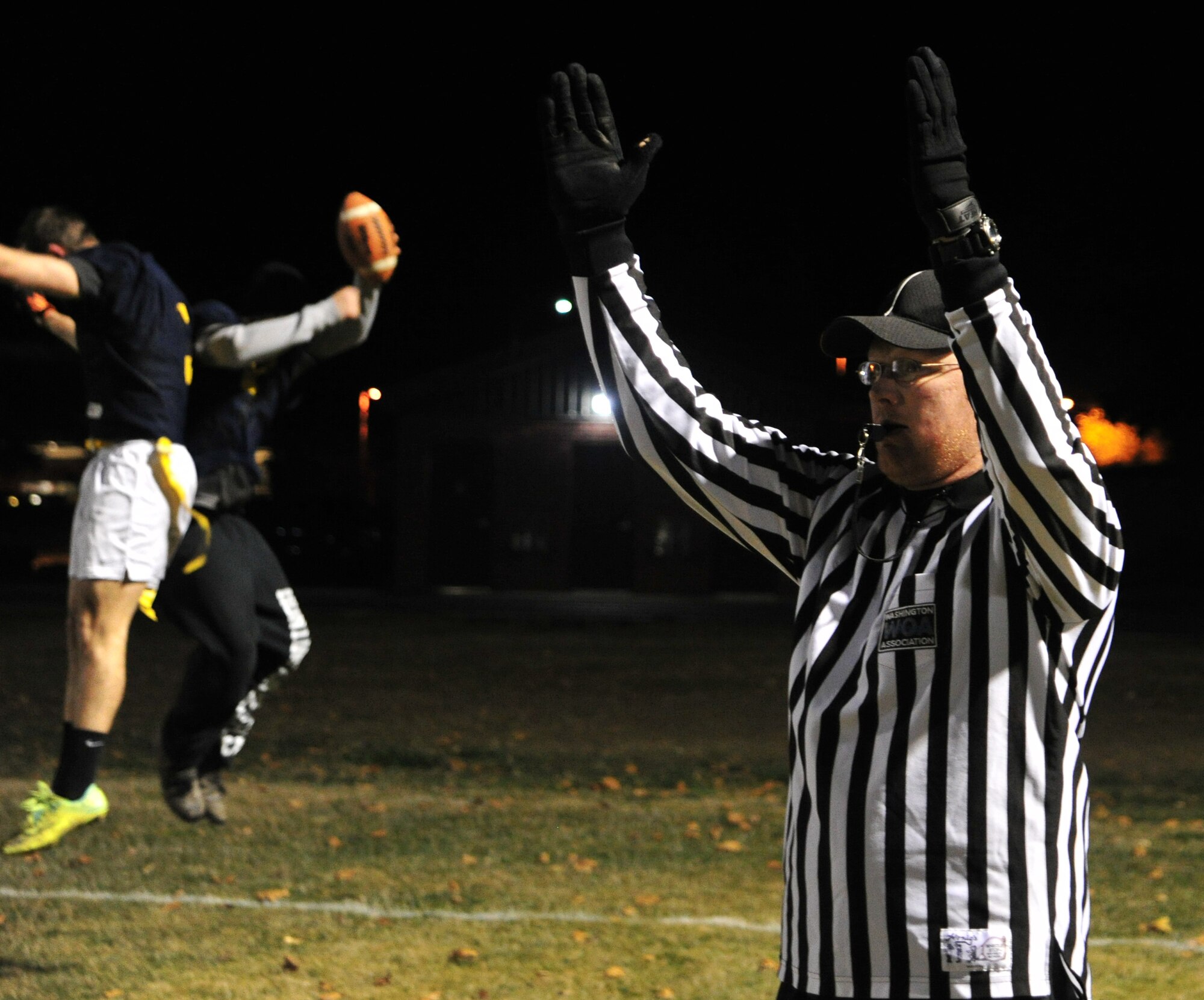 The referee signals the touchdown when a member of the 92nd Maintenance Squadron scores from a run during the intramural football championship game, Nov. 7, 2012. The touchdown tied the game in the second half. The final score ended at 17-14, MXS.  (U.S. Air Force photo by Airman 1st Class Taylor Curry)