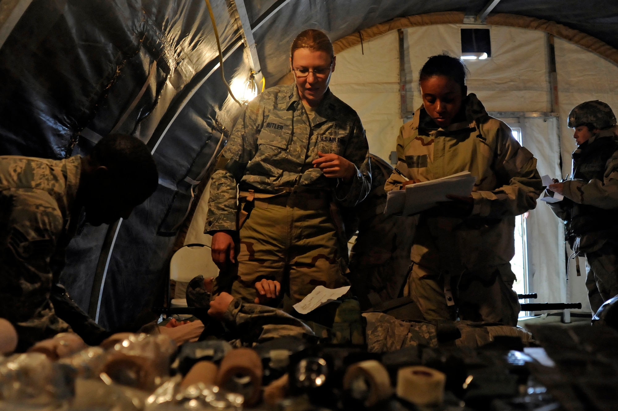 VANDENBERG AIR FORCE BASE, Calif. -- Capt. Danielle Butler, 30th Medical Operation Squadron member, works with her medical team members to triage and treat wounded Airmen during a Northstar exercise Thursday, Nov 8., 2012. The Northstar exercise is designed to test the deployment capabilities and combat survival skills of Vandenberg Airmen. (U.S. Air Force photo/Michael Peterson)