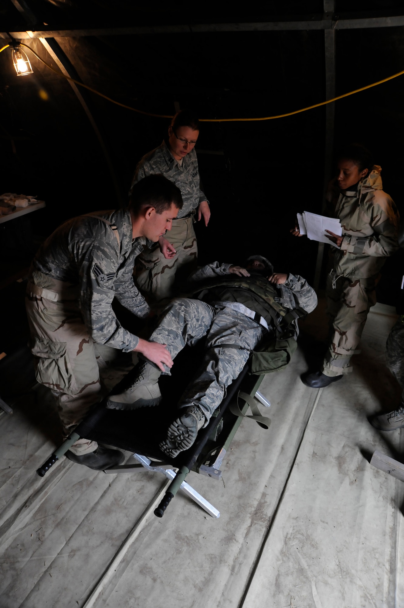 VANDENBERG AIR FORCE BASE, Calif. -- Capt. Danielle Butler, 30th Medical Operations Squadron member, works with her medical team to triage and treat a wounded Airman during a Northstar exercise Thursday, Nov 8., 2012. The Northstar exercise is designed to test the deployment capabilities and combat survival skills of Vandenberg Airmen. (U.S. Air Force photo/Michael Peterson)