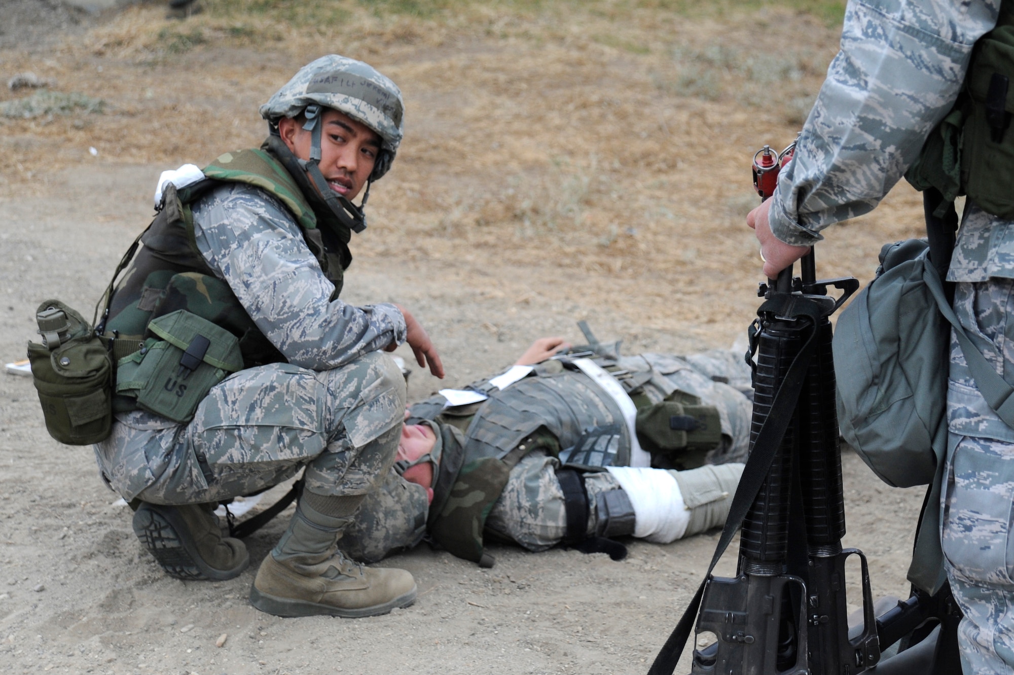 VANDENBERG AIR FORCE BASE, Calif. -- 1st Lt. Jeremi Viloria, 30th Space Wing programs requirements manager, monitors a wounded buddy until medical support arrives on scene during a Northstar exercise Thursday, Nov. 8, 2012. The Northstar exercise is designed to test the deployment capabilities and combat survival skills of Vandenberg Airmen. (U.S. Air Force photo/Michael Peterson)