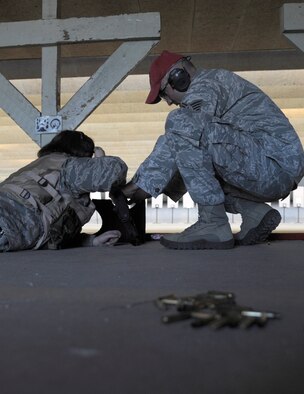 Tech. Sgt. Christopher Camara, 509th Security Forces Squadron’s Combat Arms NCOIC, assist an Airman with a weapon’s jam at the Whiteman CATM range. The 509th Security Forces Combat Arms Training and Maintenance firing range re-opened Nov. 2. (U.S. Air Force photo/Senior Airman Cody H. Ramirez) (Released)