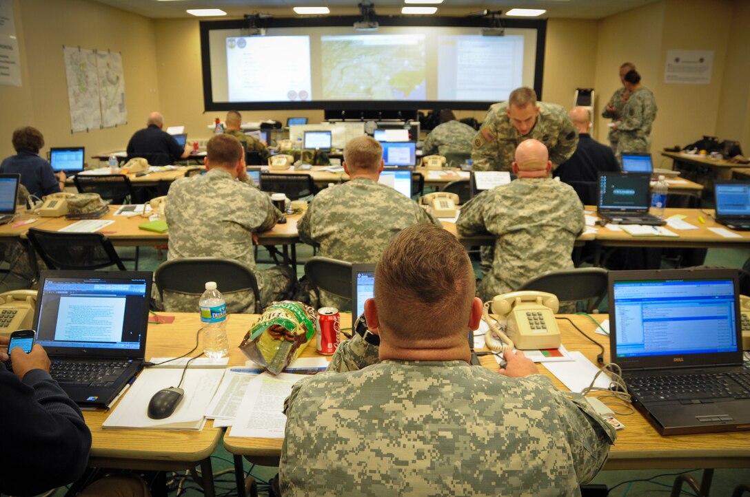 JOINT BASE MCGUIRE-DIX-LAKEHURST, N.J. -- Members of the Joint Force Land Component Command work in the JFLCC's temporary facility Nov. 7, 2012, in Building 5403 on Dix at Joint Base McGuire-Dix-Lakehurst. The JFLCC was the state's largest military coordination unit to support the hurricane-relief effort. (U.S. Air Force photo by Staff Sgt. David Carbajal/Released)