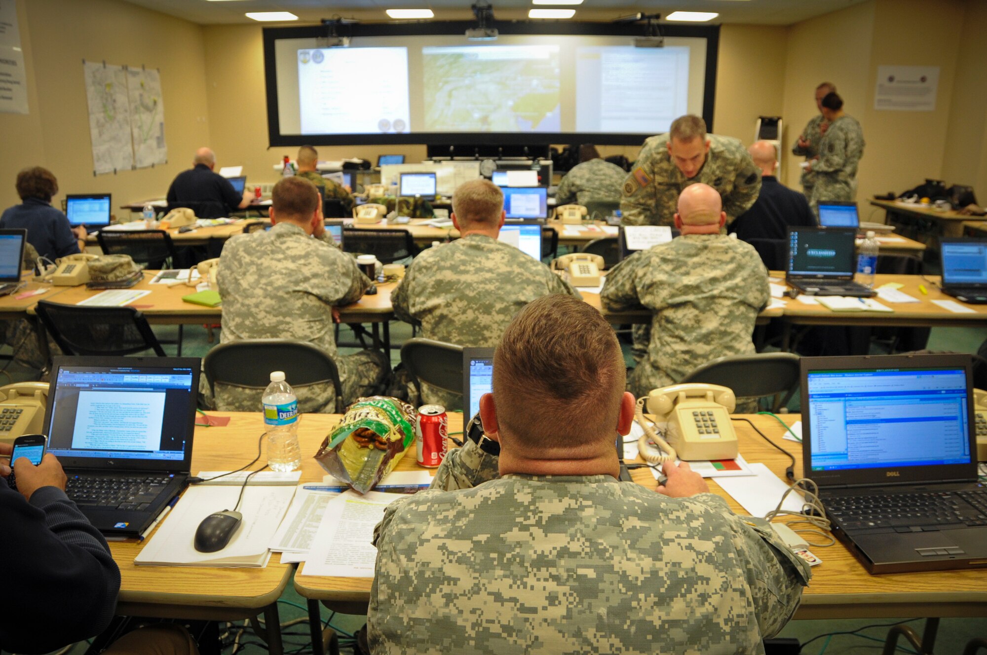 JOINT BASE MCGUIRE-DIX-LAKEHURST, N.J. -- Members of the Joint Force Land Component Command work in the JFLCC's temporary facility Nov. 7, 2012, in Building 5403 on Dix at Joint Base McGuire-Dix-Lakehurst. The JFLCC was the state's largest military coordination unit to support the hurricane-relief effort. (U.S. Air Force photo by Staff Sgt. David Carbajal/Released)