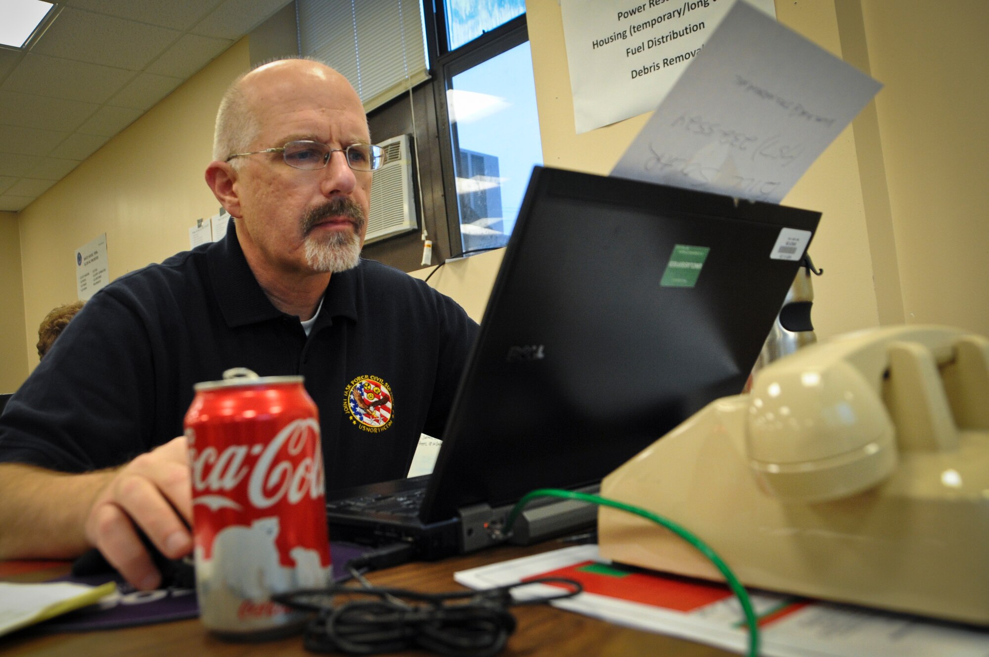 JOINT BASE MCGUIRE-DIX-LAKEHURST, N.J. -- Bill Solar, Joint Force Land Component Command information management officer, inputs information into databases at the JFLCC's temporary facility Nov. 7, 2012, in Building 5403 on Dix at Joint Base McGuire-Dix-Lakehurst. The JFLCC was the state's largest military coordination unit to support the hurricane-relief effort. (U.S. Air Force photo by Staff Sgt. David Carbajal/Released)