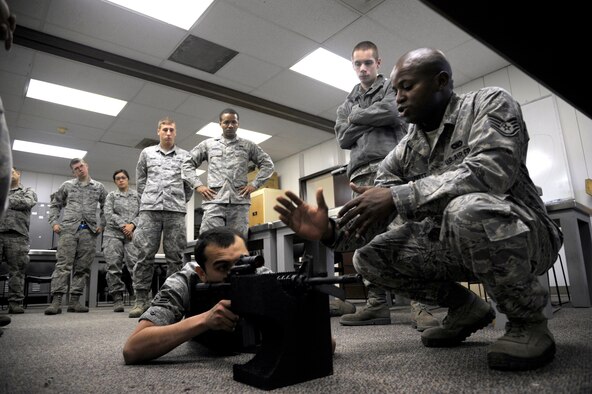 Staff Sgt. Melkeiveus Lovett, 509th Security Force Squadron combat arms training and maintenance journeyman, teaches students proper shooting stances during a CATM course at Whiteman Air Force Base, Mo., Nov. 1. Starting this month, the Whiteman CATM team will begin teaching the new Air Force stand for weapons qualification. Recently finished renovations to the firing range had prevented the CATM team from conducting the full qualification course sooner. (U.S. Air Force photo/Senior Airman Cody H. Ramirez) (Released)