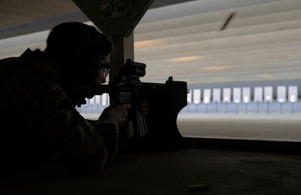 Airman 1st Class Jennifer Boll, 509th Contracting Squadron, fires during a combat arms training and maintenance qualification course at Whiteman Air Force Base, Mo., Nov. 1. Boll, and others in her class, was the first to shoot at the newly renovated firing range. The range opened with new sound barriers, a bullet trap and ventilation system and target holders.(U.S. Air Force photo/Senior Airman Cody H. Ramirez) (Released)
