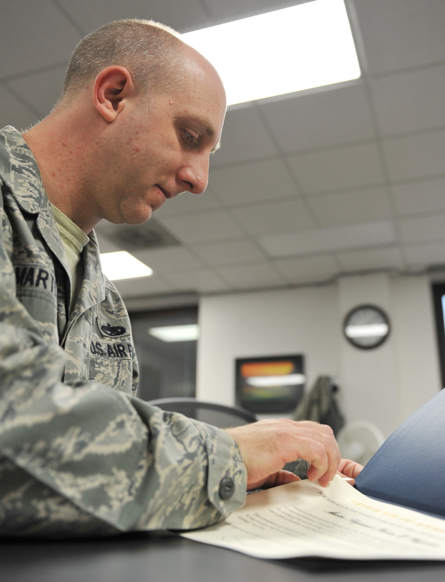 Staff Sgt. Clifford Martin, 509th Force Support Squadron NCO in charge of separations and retirements, prepares a retirement certificate during his shift at the Whiteman Air Force Base Career Development Office Oct. 31. The Career Development Office assists those transitioning in separations or retirements. (U.S. Air Force photo/Heidi Hunt) (Released)