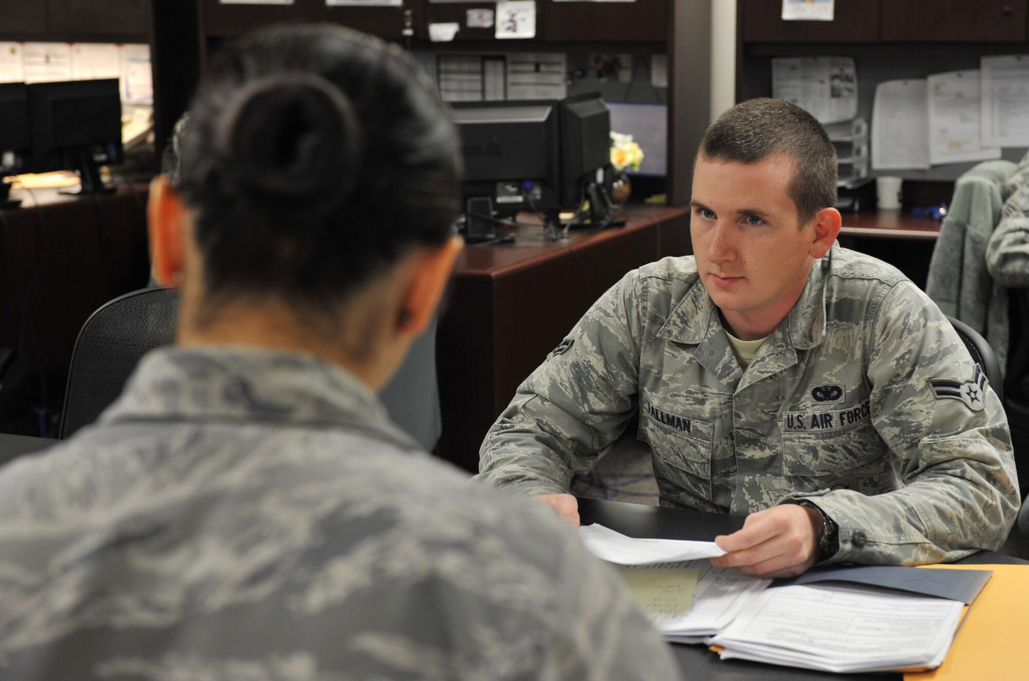 Airman 1st Class Justin Tallman, 509th Security Forces Squadron response force, listens as Senior Airman Lindsey Jaxel, 509th Force Support Squadron career development representative, explains the outprocessing instructions at the Whiteman Air Force Base Career Development Office Oct. 31. Career Development representatives guide members to help Airmen reach their career goals. (U.S. Air Force photo/Heidi Hunt) (Released)