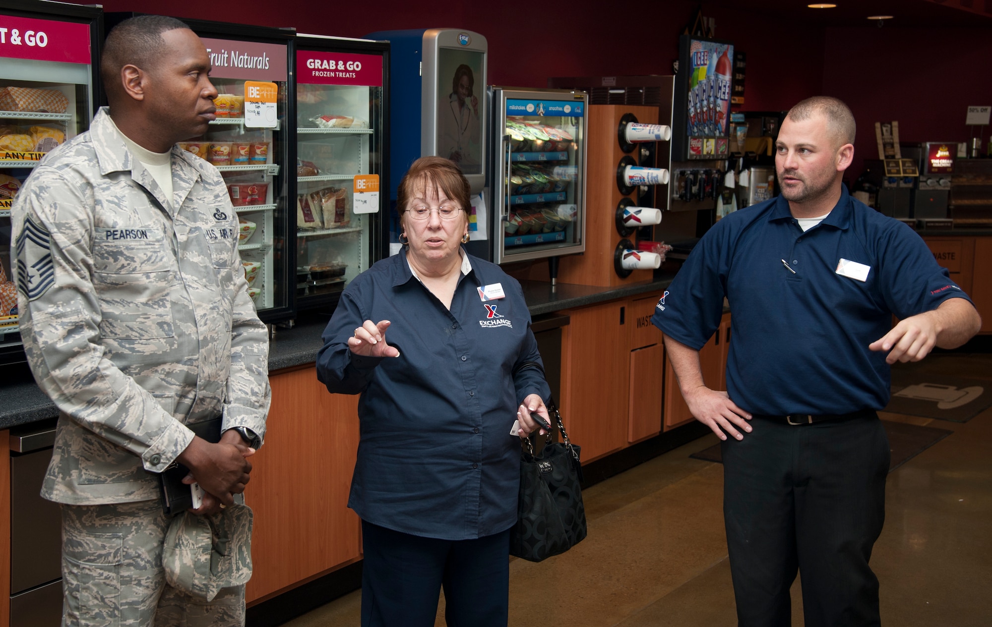 Chief Master Sgt. Anthony Pearson, Army & Air Force Exchange Service senior enlisted advisor, Phyllis Keister Exchange general manager and Jeffrey Carroll Mini Mall manager discuss future goals for the Mini Mall at Holloman Air Force Base, N.M., Nov. 8. Pearson toured Exchange facilities, met with Airmen and community members, and addressed Exchange-related issues. Pearson serves as the focal point for communications between Exchange leadership and 12.5 million Army and Air Force active duty, Guard, Reserve, family members and retired patrons. (U.S. Air Force photo by Airman 1st Class Colin Cates/Released) 