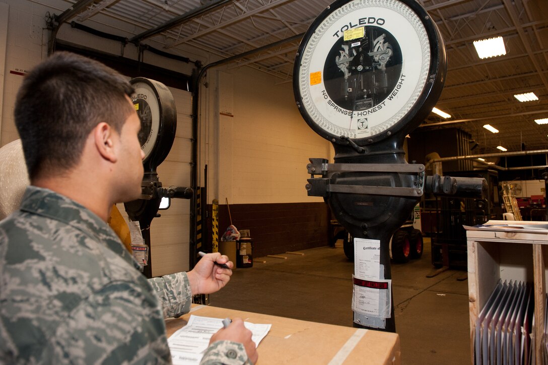 Senior Airman Josue Diaz, 28th Logistics Readiness Squadron packing and crating technician, weighs a package before shipping the item in the packing and crating shop at Ellsworth Air Force Base, S.D., Nov. 2, 2012. The 28th LRS packing and crating section is responsible for all cargo shipments to and from Ellsworth and ensuring on-time delivery of mission essential items. (U.S. Air Force photo by Airman 1st Class Kate Thornton-Maurer/Released)