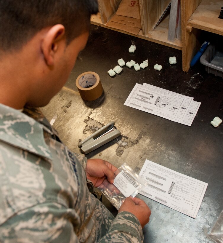 Senior Airman Josue Diaz, 28th Logistics Readiness Squadron packing and crating technician, verifies product identification numbers in preparation for shipping an item in the packing and crating shop at Ellsworth Air Force Base, S.D., Nov. 2, 2012. The 28th LRS packing and crating section is responsible for verifying all aircraft part and supply documents to ensure the correct item reaches its final destination. (U.S. Air Force photo by Airman 1st Class Kate Thornton-Maurer/Released)