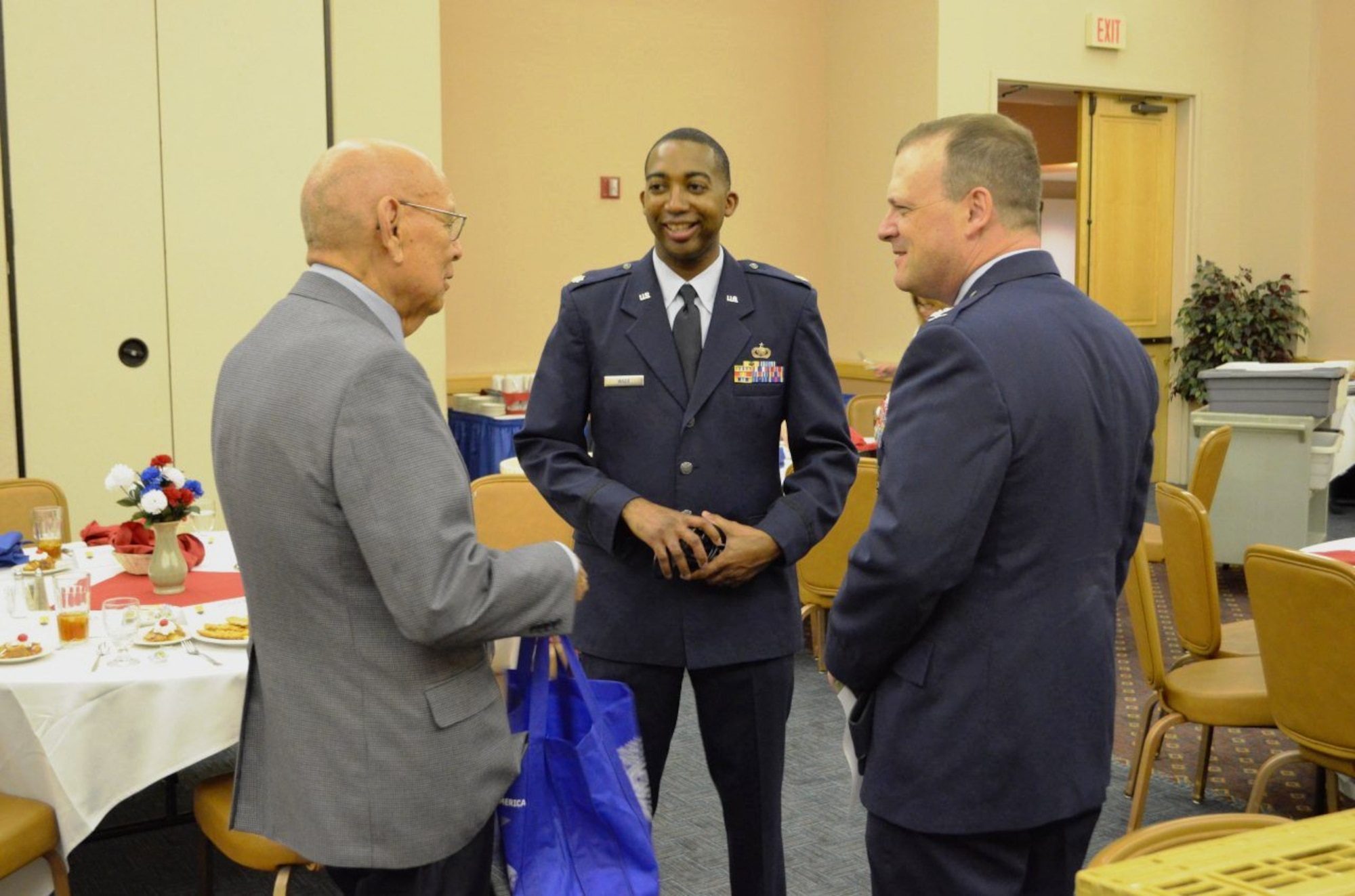 Tino Duran(left), owner and publisher of two local bilingual newspapers, also known as the godfather of Spanish media, talks with Col. Craig Petersen, 433rd Mission Support Group commander, right, and Major Timothy Wade, chief of public affairs after the 433rd Honorary Commanders induction ceremony, Nov.3 on Joint Base San Antonio-Lackland.  “Once I get into it, I want to write about it. I am praying this gives me a profound insight into what you do, and then I can verbalize it in writing for the general public in San Antonio,” said Duran. (U.S. Air Force photo by SMSgt Minnie Jones)