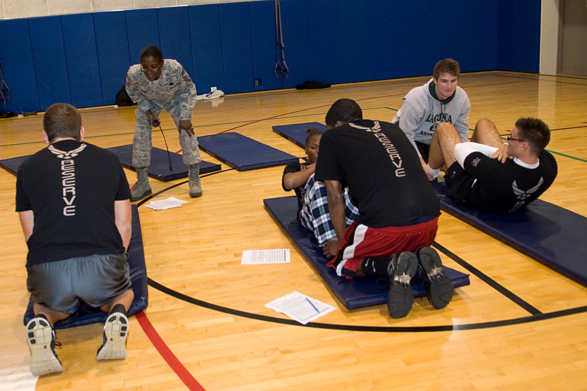 GRISSOM AIR RESERVE BASE, Ind. -- Chief Master Sgt. Tamara Jones, 434th Development and Training Flight facilitator, encourages trainees to push out one last sit-up before their time is up during a practice physical fitness test during the November unit training assembly. The purpose of the 434th D&TF is to prepare new enlisted Airmen for basic training and to help with long-term retention. (U.S. Air Force photo/Staff Sgt. Ben Mota)