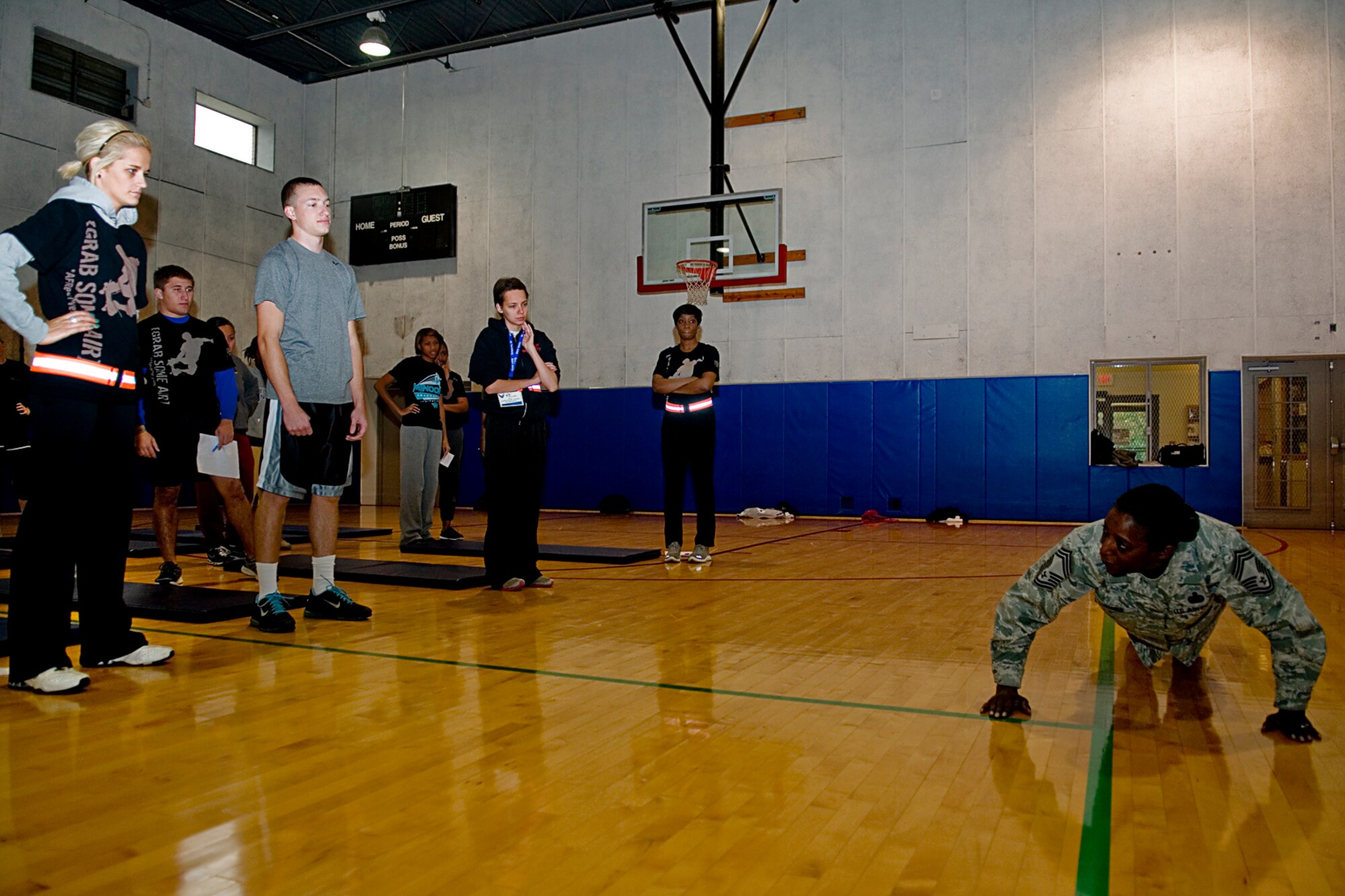 GRISSOM AIR RESERVE BASE, Ind. -- Chief Master Sgt. Tamara Jones, 434th Development and Training Flight facilitator, demonstrates a proper push-up to trainees during the November unit training assembly. The purpose of the 434th D&TF is to prepare new enlisted Airmen for basic training and to help with long-term retention. (U.S. Air Force photo/Staff Sgt. Ben Mota)