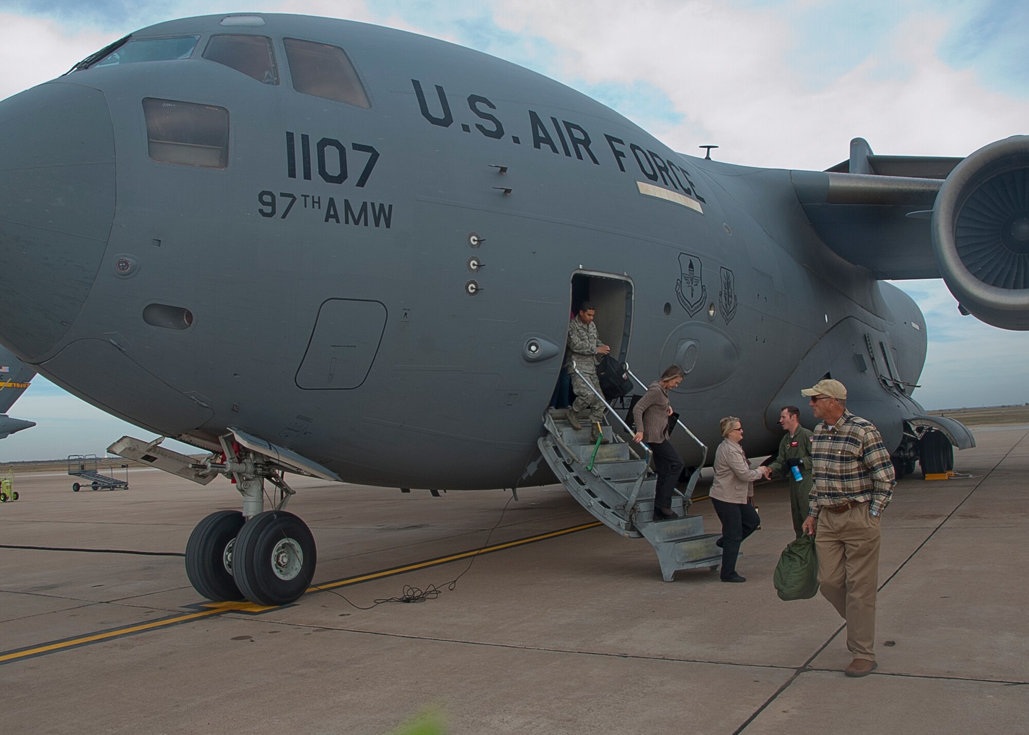 ALTUS AIR FORCE BASE, Okla. – Altus community members exit a C-17 Globemaster III after going on a Farm City Week incentive flight, Nov. 8, 2012. During the incentive flight, the community members experienced an in-flight refueling from the inside of a KC-135 Stratotanker and a C-17 Globemaster III. Farm City Week has been held annually for the past 35 years to highlight the importance of agriculture in the local community and invite members of the community on the base to learn and experience the mission of Altus AFB first-hand. (U.S. Air Force photo by Airman 1st Class Levin Boland / Released)