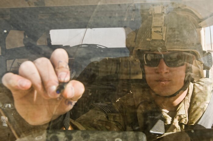 A U.S. Air Force Tactical Air Control Party Airman writes coordinates down on his vehicle's windshield during Green Flag-West 13-2  Nov. 7, 2012, at the National Training Center, Fort Irwin, Calif. TACPs are Ranger and Airborne qualified, and are proficient in static line and high-altitude, low-open parachute tactics, as well as in air assault and scuba operations. (U.S. Air Force Photo by Senior Airman Daniel Hughes)
