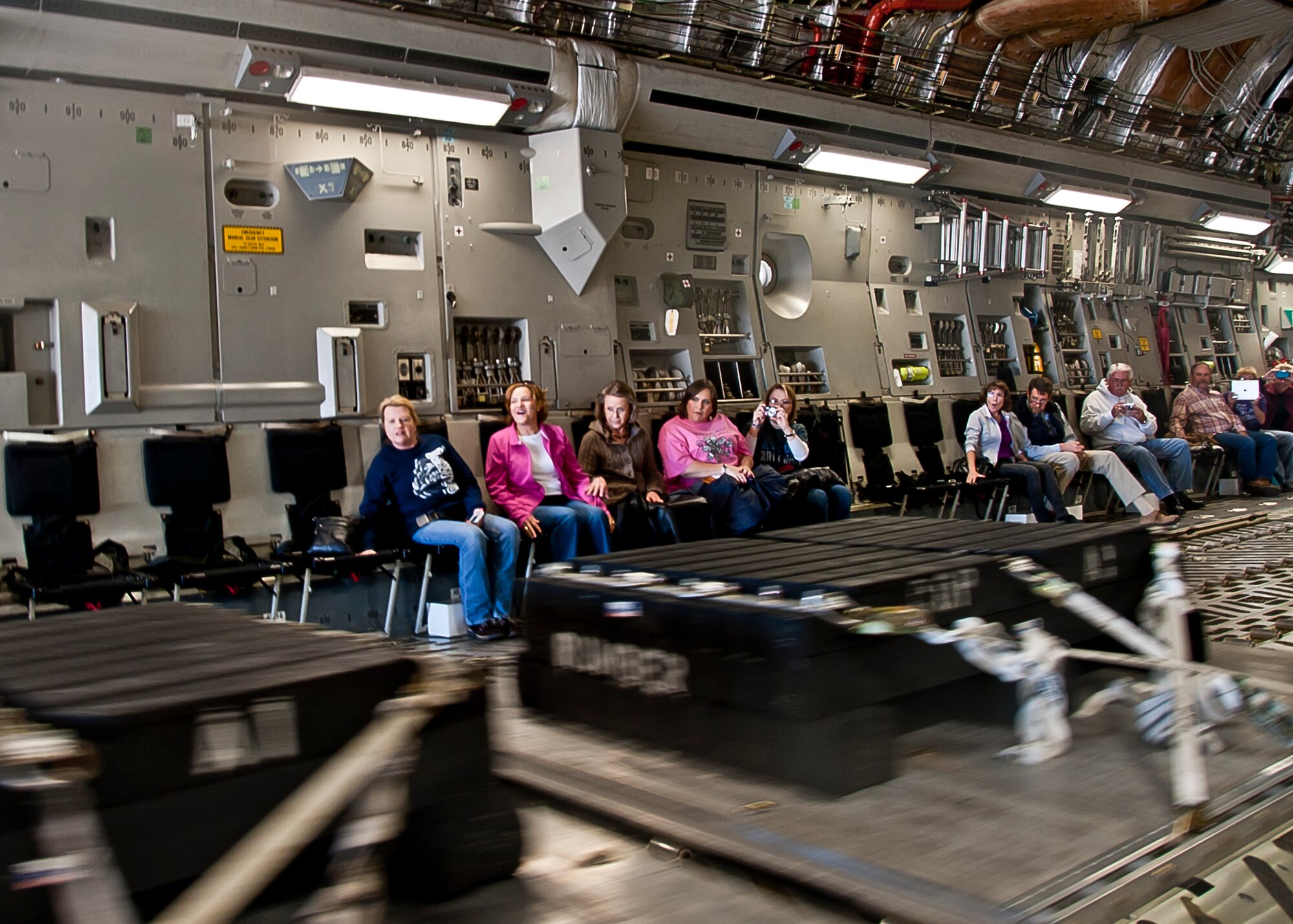 ALTUS AIR FORCE BASE, Okla. – City of Altus community members watch a demonstration of a Combat Offload from inside a C-17 Globemaster III during a Farm City Week incentive flight, Nov. 8, 2012. The Combat Offload procedure allows the C-17 aircrew to deliver cargo quickly in a combat situation. Farm City Week has been held annually for the past 35 years to highlight the importance of agriculture in the local community and invite members of the community on the base to learn and experience the mission of Altus AFB first-hand. (U.S. Air Force photo by Airman 1st Class Levin Boland / Released)