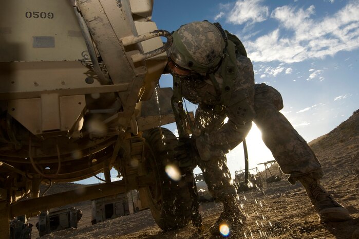 U.S. Army Pfc. Nicholas Gates, 1st Brigade medic, drinks water from the water barrel during Green Flag-West 13-2 Nov. 7, 2012, at the National Training Center at Fort Irwin, Calif. Staying hydrated is critical in preventing heat injury during troop movements. (U.S. Air Force Photo by Senior Airman Daniel Hughes)
