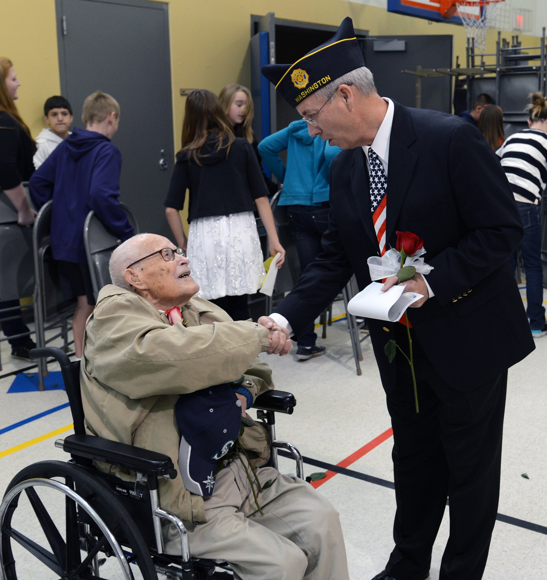 Steve Cofchin, veteran of the U.S. Air Force and Navy and guest speaker, shakes the hand of World War II veteran Joseph Fox after the Meeker Elementary School Veterans Day assembly, Nov. 8, 2012. Fox and Cofchin, along with numerous other veterans, were honored at the Puyallup, Wash., school as part of their salute to veterans. (U.S. Air Force photo/Master Sgt. Todd Wivell)