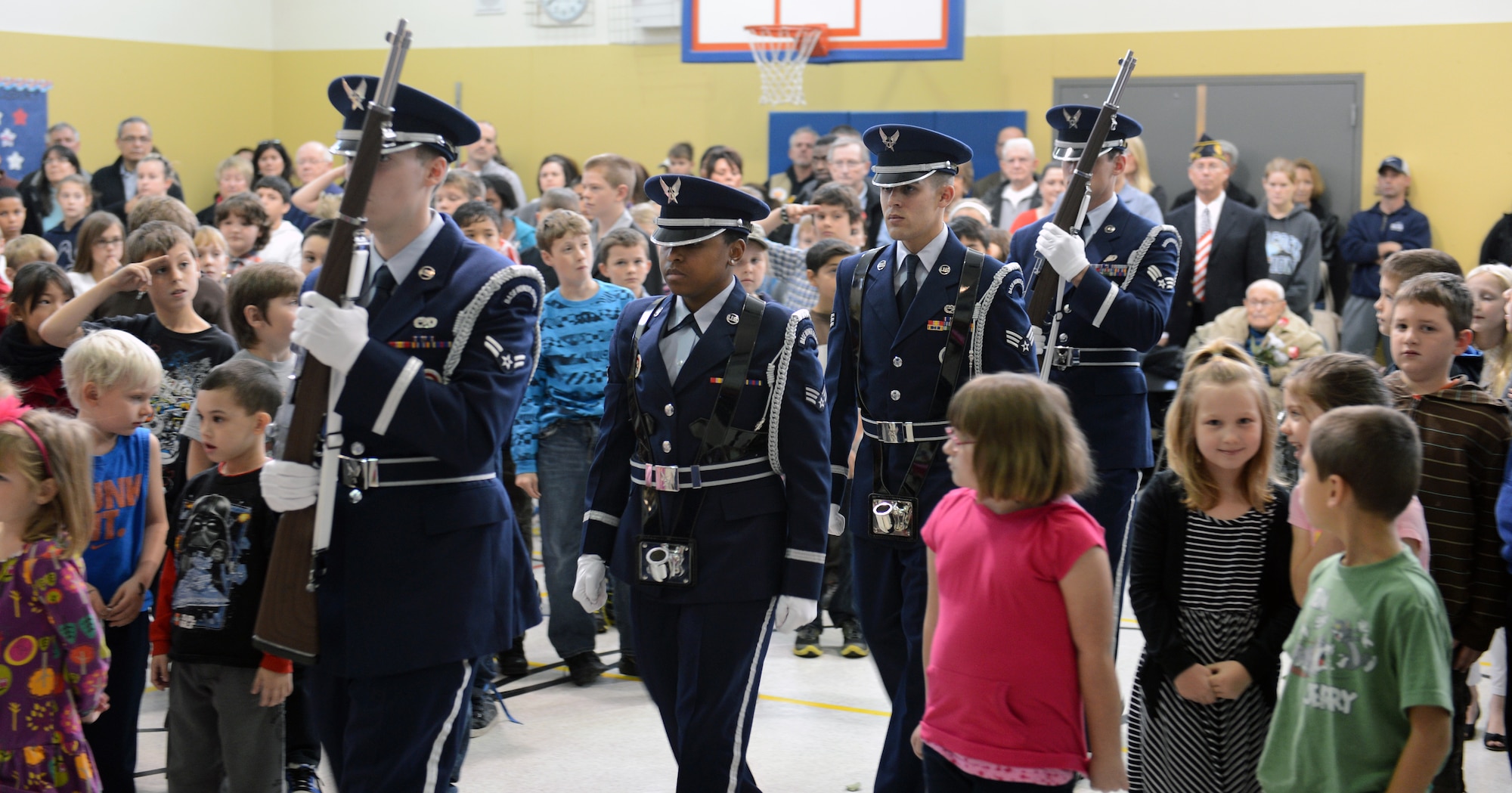 McChord Field Honor Guard members, assigned to Joint Base Lewis-McChord, Wash., prepare to retire the colors at the Meeker Elementary School Veterans Day assembly, Nov. 8, 2012 at Puyallup, Wash. More than 400 students and 100 guests attended to watch this remembrance ceremony at the local school. (U.S. Air Force photo/Master Sgt. Todd Wivell)
