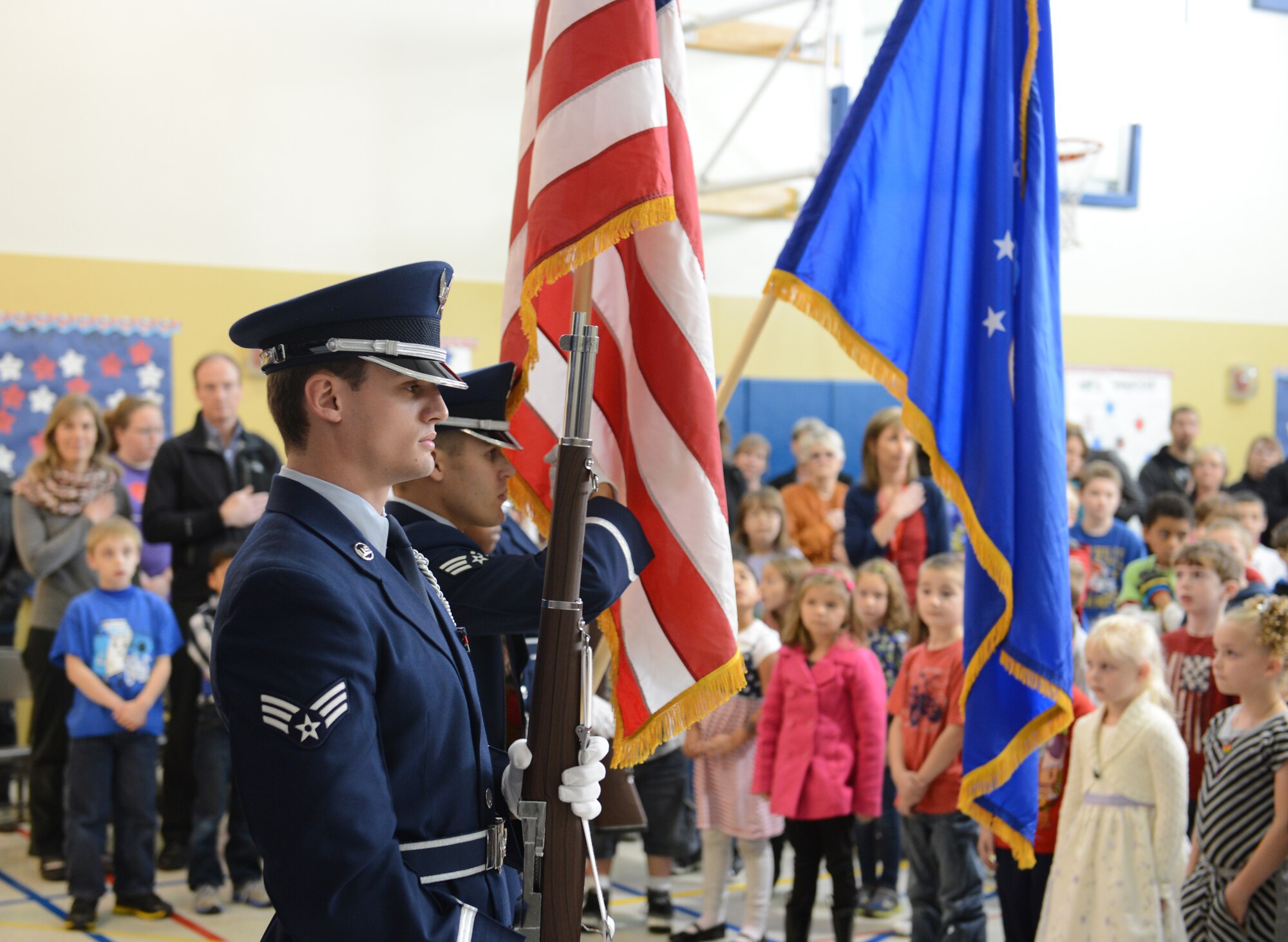 Senior Airmen John Krook and Adam Wray McChord Field honor guard members, assigned to Joint Base Lewis-McChord, Wash., present the colors at the Meeker Elementary School Veterans Day assembly, Nov. 8, 2012. Meeker Elementary school is located in Puyallup, Wash., and is one of numerous schools the base supported for Veterans Day remembrances. (U.S. Air Force photo/Master Sgt. Todd Wivell)