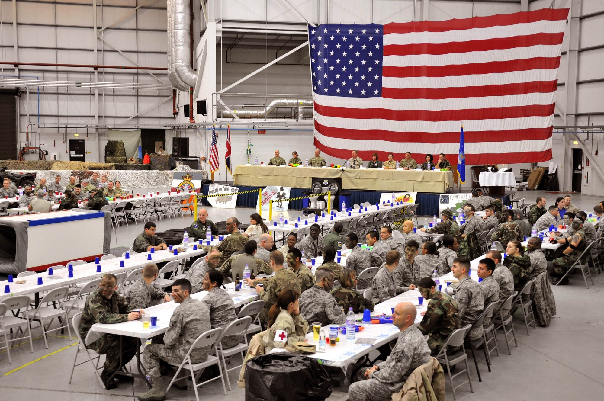 Team Mildenhall Airmen attend the base’s combat dining out in Hangar 814, Nov. 9, 2012, at RAF Mildenhall, England. The event was sponsored by the Team Mildenhall Top 3, and served as a morale-building event for enlisted Airmen throughout the base. (U.S. Air Force photo by Senior Airman Jerilyn Quintanilla/Released)