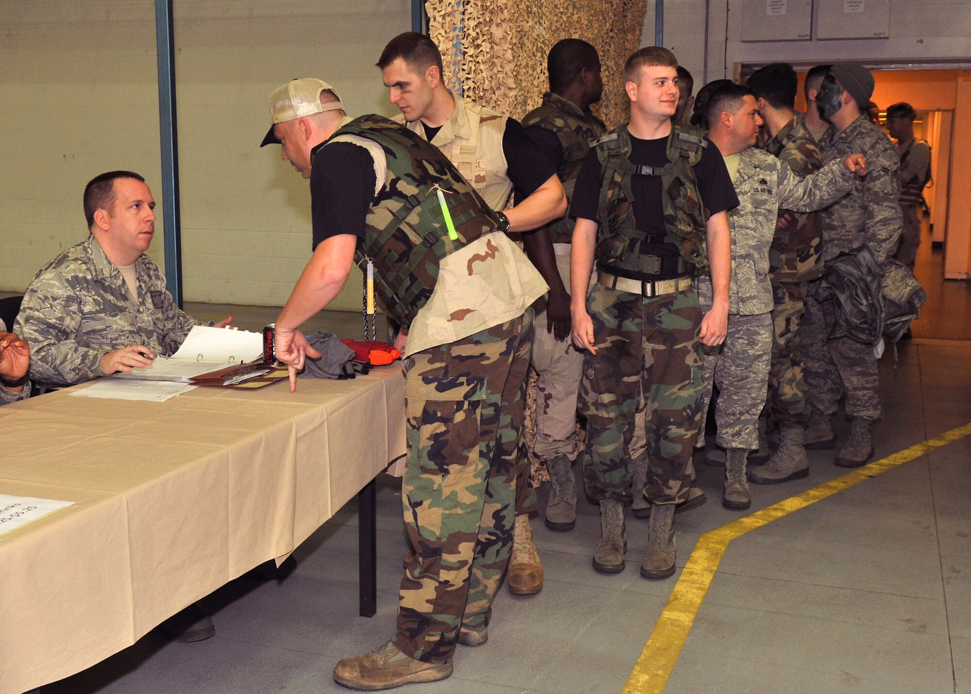 Team Mildenhall Airmen sign in upon arrival to the base’s combat dining out in Hangar 814, Nov. 9, 2012, at RAF Mildenhall, England. The time-honored tradition serves as a morale building event for the enlisted Airmen. (U.S. Air Force photo by Senior Airman Jerilyn Quintanilla/Released)