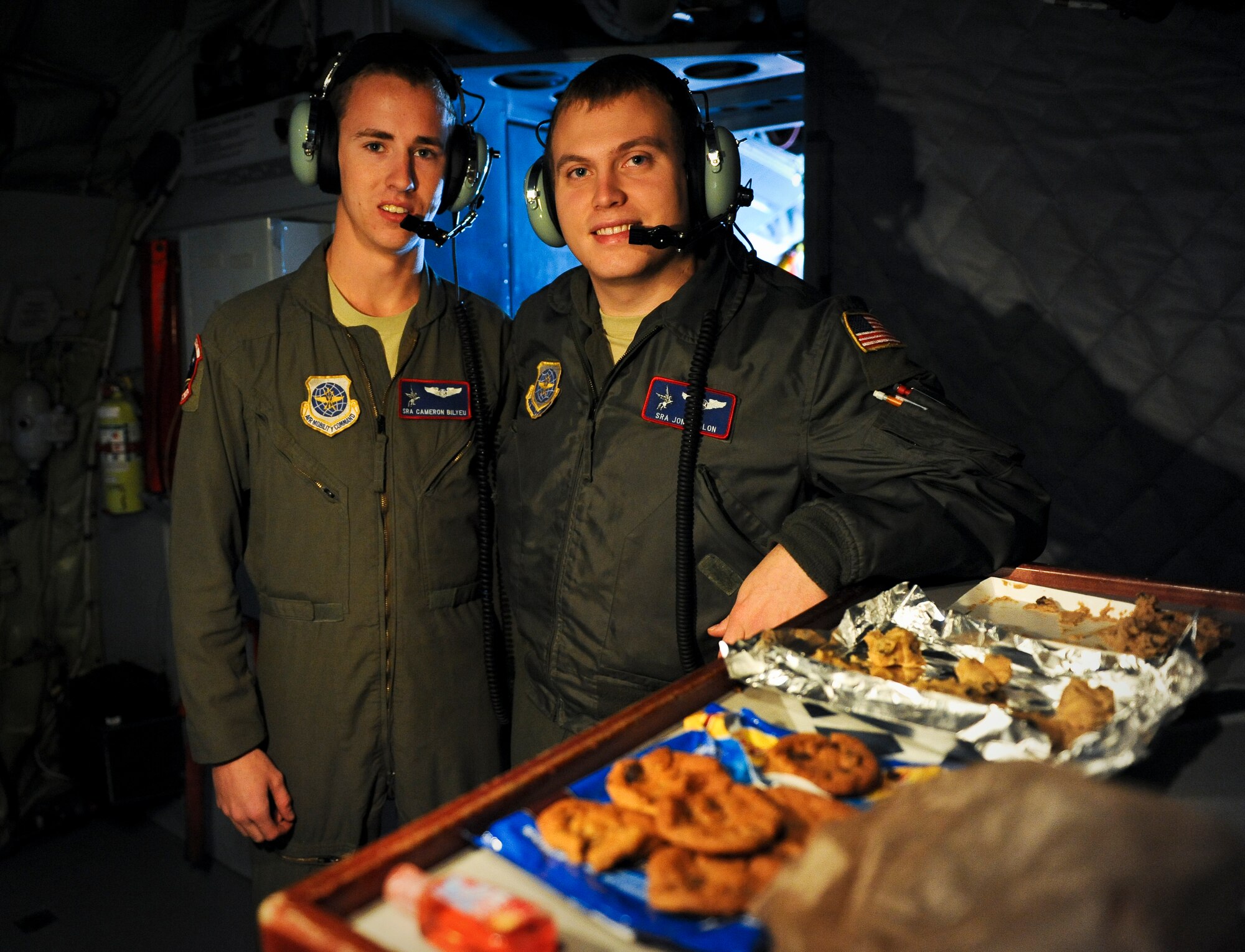 Senior Airmen Cameron Bilyeu and Jonathan Mellon pose with the chocolate chip cookies they made for the spouses who flew in a KC-135 Stratotanker during a spouses orientation flight over Washington and Oregon Nov. 7, 2012. Fairchild spouses flew as part of an ongoing program designed to orient them with what it means to be an Airman here. Participants wore their respective husband’s flight suits adding to the overall realness of the experience. Bilyeu and Mellon are 93rd Air Refueling Squadron boom operators. (U.S. Air Force photo by Senior Airman Benjamin Stratton)