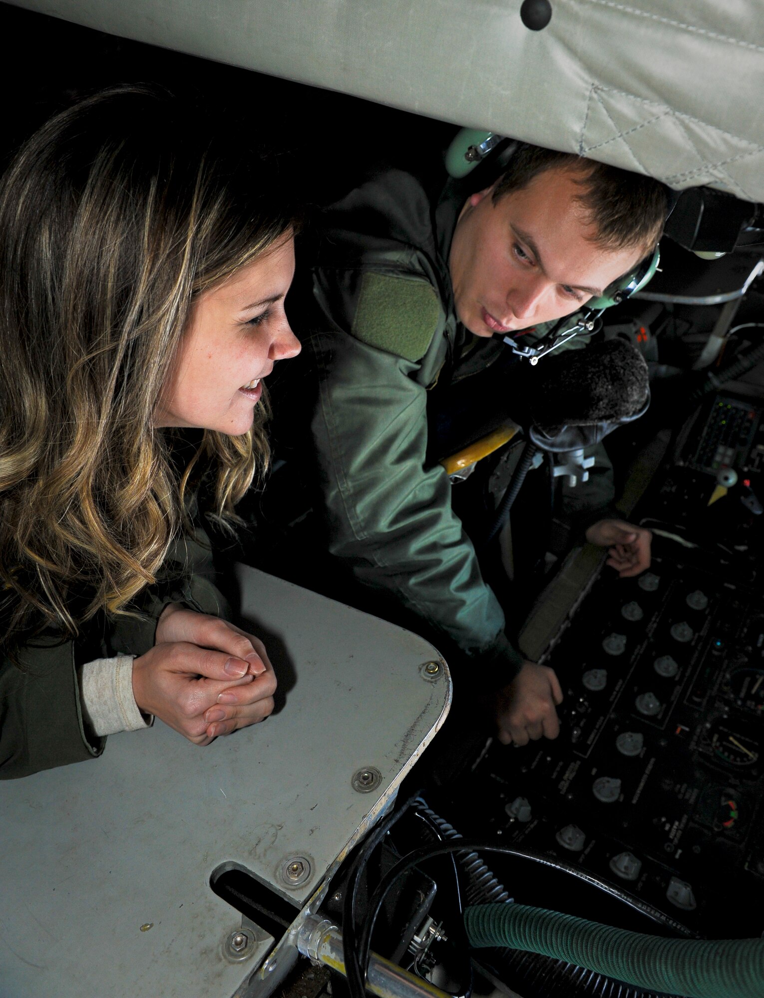Senior Airman Jonathan Mellon shows Ann Greer how to operate the boom of a KC-135 Stratotanker during a spouses orientation flight over Washington and Oregon Nov. 7, 2012. Fairchild spouses flew as part of an ongoing program designed to orient them with what it means to be an Airman here. Participants wore their respective husband’s flight suits adding to the overall realness of the experience. Mellon is a 93rd Air Refueling Squadron boom operator and Greer is the wife of Capt. Adam Greer also from the 93rd ARS and a pilot. (U.S. Air Force photo by Senior Airman Benjamin Stratton)