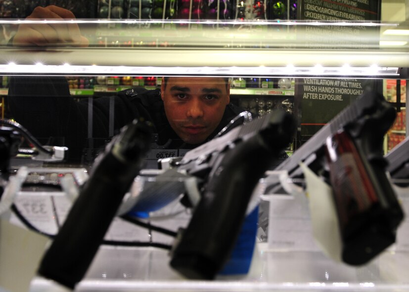 Tech Sgt. Julio Serrano, 9th Force Support Squadron, shops for a handgun at the Exchange at Beale Air Force Base, Calif., Nov. 5, 2012. The exchange has sold more than 40 firearms after beginning to sell them Nov. 2. Purchasers are required to pass a background check and fulfill a 10 day waiting period before taking home a firearm. (U.S. Air Force photo by Senior Airman Shawn Nickel/Released)