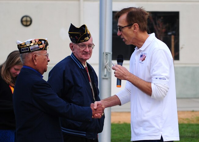 Steve Albecht (right), Bear River Middle School teacher, thanks William "Smoky" Davis (middle) and Molina "Mo" Augustin (left) for their service during a flag ceremony at Bear River Middle School, Wheatland, Calif., Nov. 9, 2012. Students were encouraged to invite family servicemembers to the ceremony honoring veterans. Davis served in the Army from 1951-74 starting at the age of 15 after lying about his age to join the Army. Augustin served in the U.S. Army and later in the Air Force from 1944-70. (U.S. Air Force photo by Senior Airman Shawn Nickel/Released)