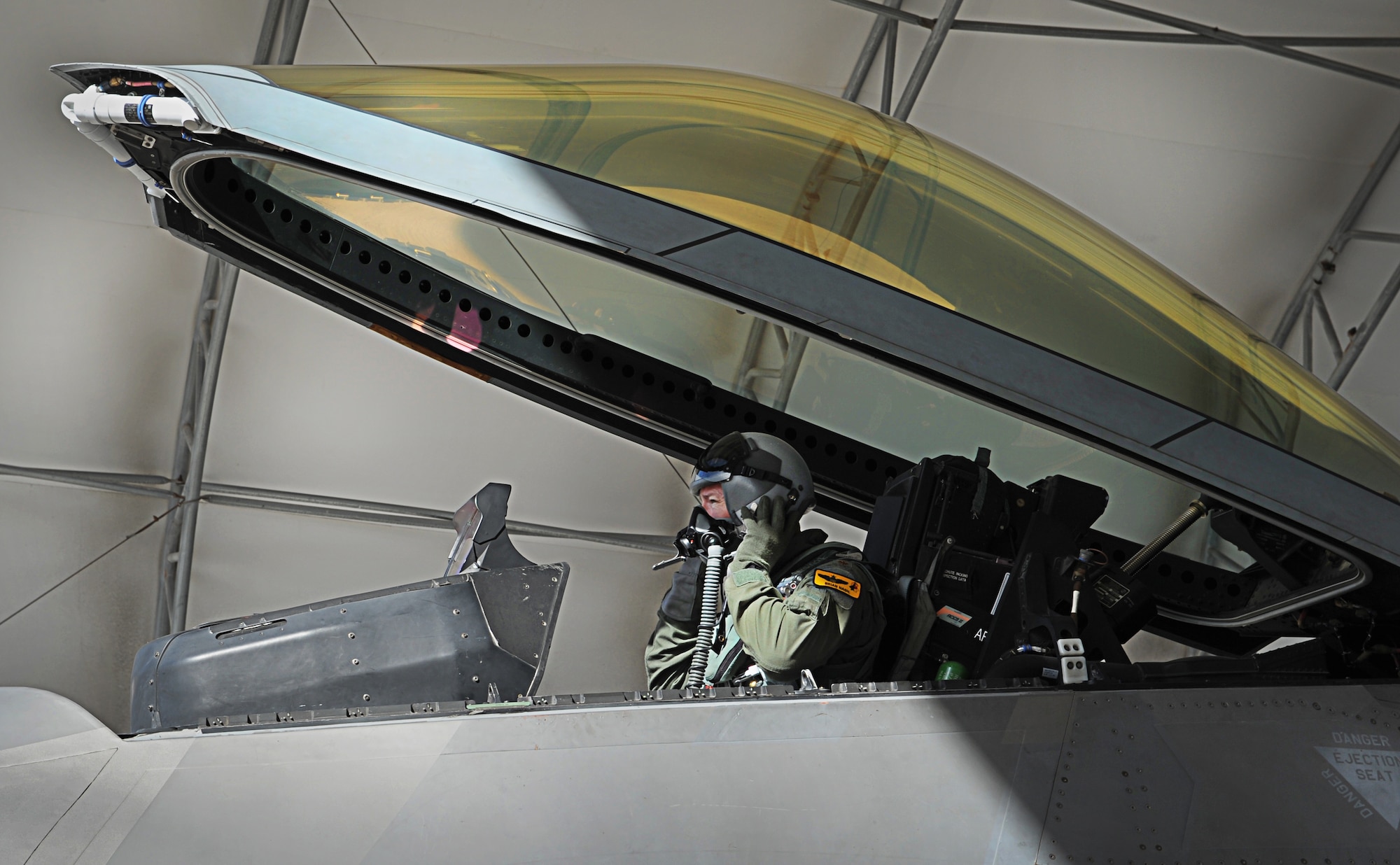 Maj. Brian Nash, an F-22 instructor pilot with the 19th Fighter Squadron, prepares to fly during  an Initial Operational Capability (IOC) certification Nov. 8. The F-22 Raptor is the Air Force's newest fighter aircraft. Its combination of stealth, super-cruise, maneuverability, and integrated avionics, coupled with improved supportability, represents an exponential leap in war fighting capabilities. (U.S. Air Force photo/Senior Airman Lauren Main)