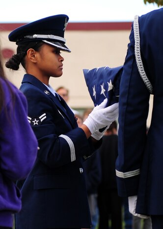 Airman 1st Class Kristina Burce, a member of the Beale Air Force BaseHonor Guard, prepares to unfurl Old Glory during a flag ceremony at Bear River Middle School, Calif., Nov. 9, 2012. Many students at Bear River middle school are children of Beale Airmen. (U.S. Air Force photo by Senior Airman Shawn Nickel/Released)