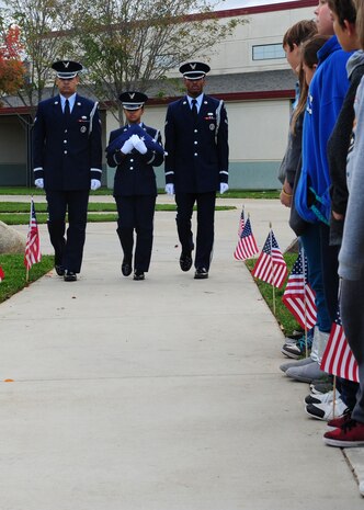 Members of the Beale Air Force Base Honor Guard march the U.S. flag past students during a flag ceremony at Bear River Middle School, Calif., Nov. 9, 2012. Students were encouraged to invite family servicemembers to the ceremony. (U.S. Air Force photo by Senior Airman Shawn Nickel/Released)