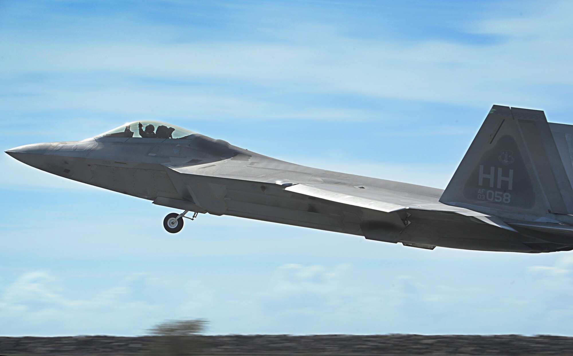 An F-22 Raptor takes off from Joint Base Pearl Harbor-Hickam, Hawaii, during an Initial Operational Capability (IOC) certification Nov. 8. The F-22 will have better reliability and maintainability than any fighter aircraft in history.  Increased F-22 reliability and maintainability pays off in less manpower required to fix the aircraft and the ability to operate more efficiently. (U.S. Air Force photo/Senior Airman Lauren Main)