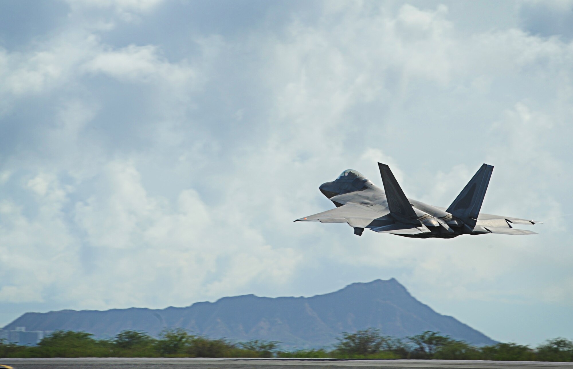 An F-22 Raptor  takes off from Joint Base Pearl Harbor-Hickam, Hawaii, during an Initial Operational Capability (IOC) certification Nov. 8. The F-22 engines produce more thrust than any current fighter engine. The combination of sleek aerodynamic design and increased thrust allows the F-22 to cruise at supersonic airspeeds without using afterburner. (U.S. Air Force photo/Senior Airman Lauren Main)