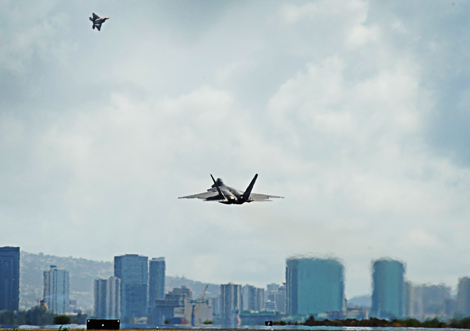 F-22 Raptors  take off from Joint Base Pearl Harbor-Hickam, Hawaii, during an Initial Operational Capability (IOC) certification Nov. 8. The F-22 engines produce more thrust than any current fighter engine. The combination of sleek aerodynamic design and increased thrust allows the F-22 to cruise at supersonic airspeeds without using afterburner. (U.S. Air Force photo/Senior Airman Lauren Main)