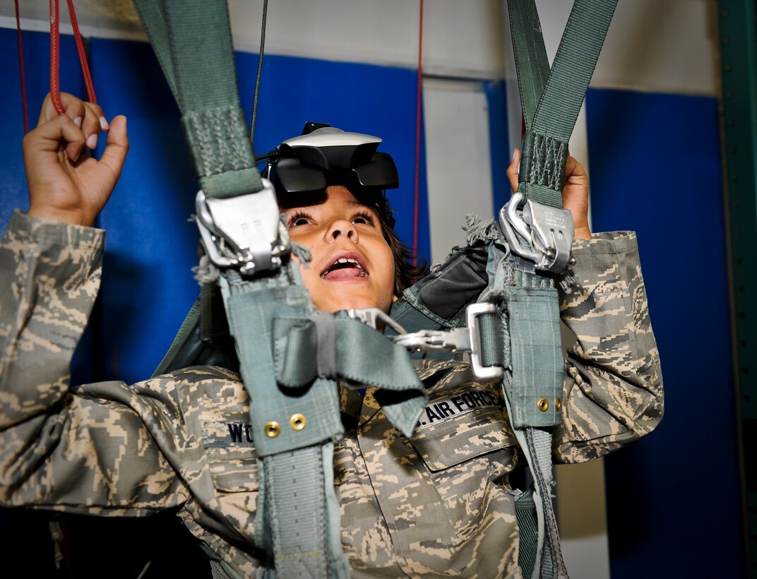 Trevion Worthy “parachutes” in the survival school’s parachuting simulator along his journey as ‘Airman for a Day’ at Fairchild Air Force Base, Wash., Nov. 2, 2012. Tre was the second youth to participate in the program at Fairchild that gives children a break from challenges they face on a day-to-day basis. Tre has been fighting Acute Lymphoblastic Leukemia and undergone almost two years of chemo therapy. (U.S. Air Force photo by Senior Airman Benjamin Stratton)