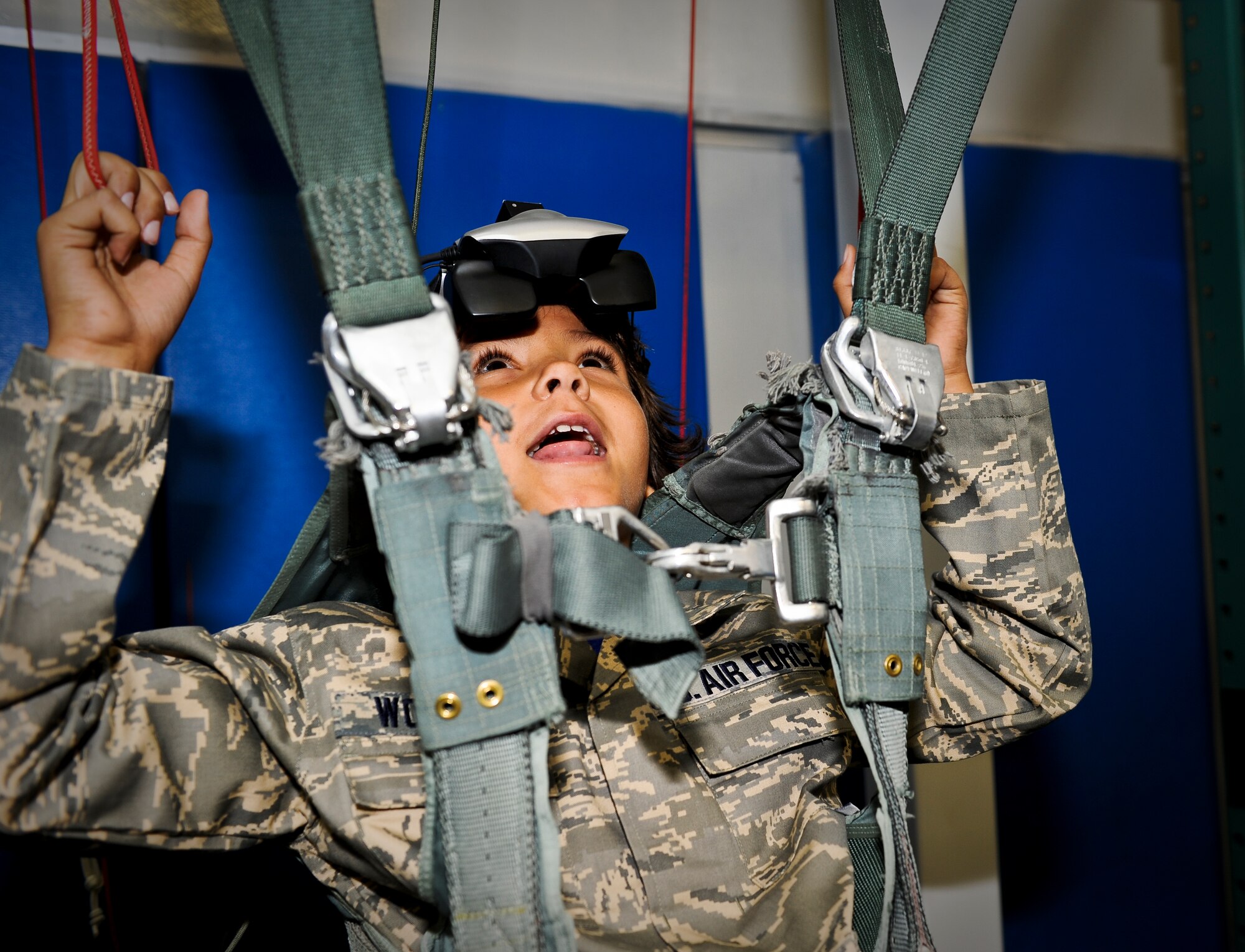 Trevion Worthy “parachutes” in the survival school’s parachuting simulator along his journey as ‘Airman for a Day’ at Fairchild Air Force Base, Wash., Nov. 2, 2012. Tre was the second youth to participate in the program at Fairchild that gives children a break from challenges they face on a day-to-day basis. Tre has been fighting Acute Lymphoblastic Leukemia and undergone almost two years of chemo therapy. (U.S. Air Force photo by Senior Airman Benjamin Stratton)