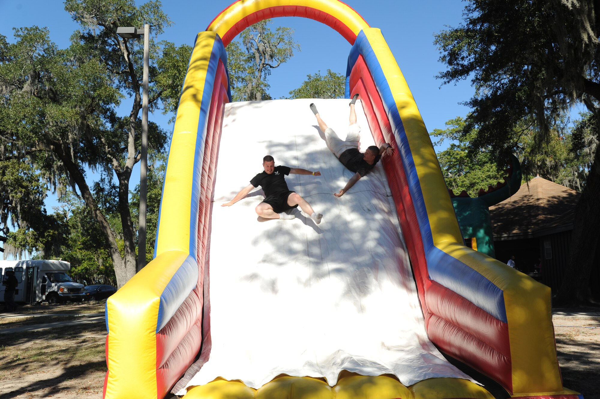 Airman 1st Class Brody Forbes, and Airman Basic Christopher Frietsch, 335th Training Squadron, take advantage of the inflatable rock climb at the consolidated unit inspection celebration picnic Nov. 7, 2012, at the Marina Park, Keesler Air Force Base, Miss.  (U.S. Air Force photo by Kemberly Groue)