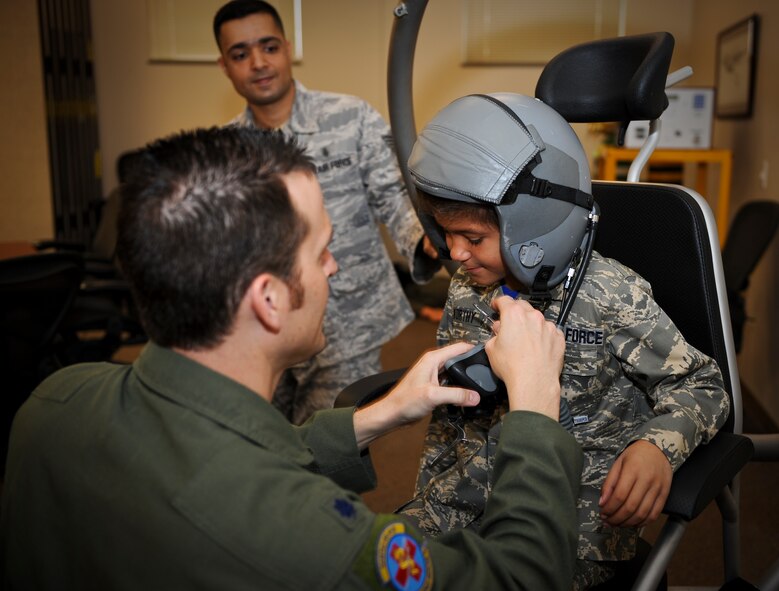 Trevion Worthy is talked with by Lt. Col. Matt Albright about the effects of hypoxia and disorientation on pilots as Staff Sgt. Vikas Kumar looks on during his stop at aerospace physiology along his journey as ‘Airman for a Day’ at Fairchild Air Force Base, Wash., Nov. 2, 2012. Albright is the 92nd Aerospace Medicine Squadron aerospace physiological training flight commander and Kumar is a 92nd AMDS aerospace physiology technician. Tre was the second youth to participate in the program at Fairchild that gives children a break from challenges they face on a day-to-day basis. Tre has been fighting Acute Lymphoblastic Leukemia and undergone almost two years of chemo therapy. (U.S. Air Force photo by Senior Airman Benjamin Stratton)