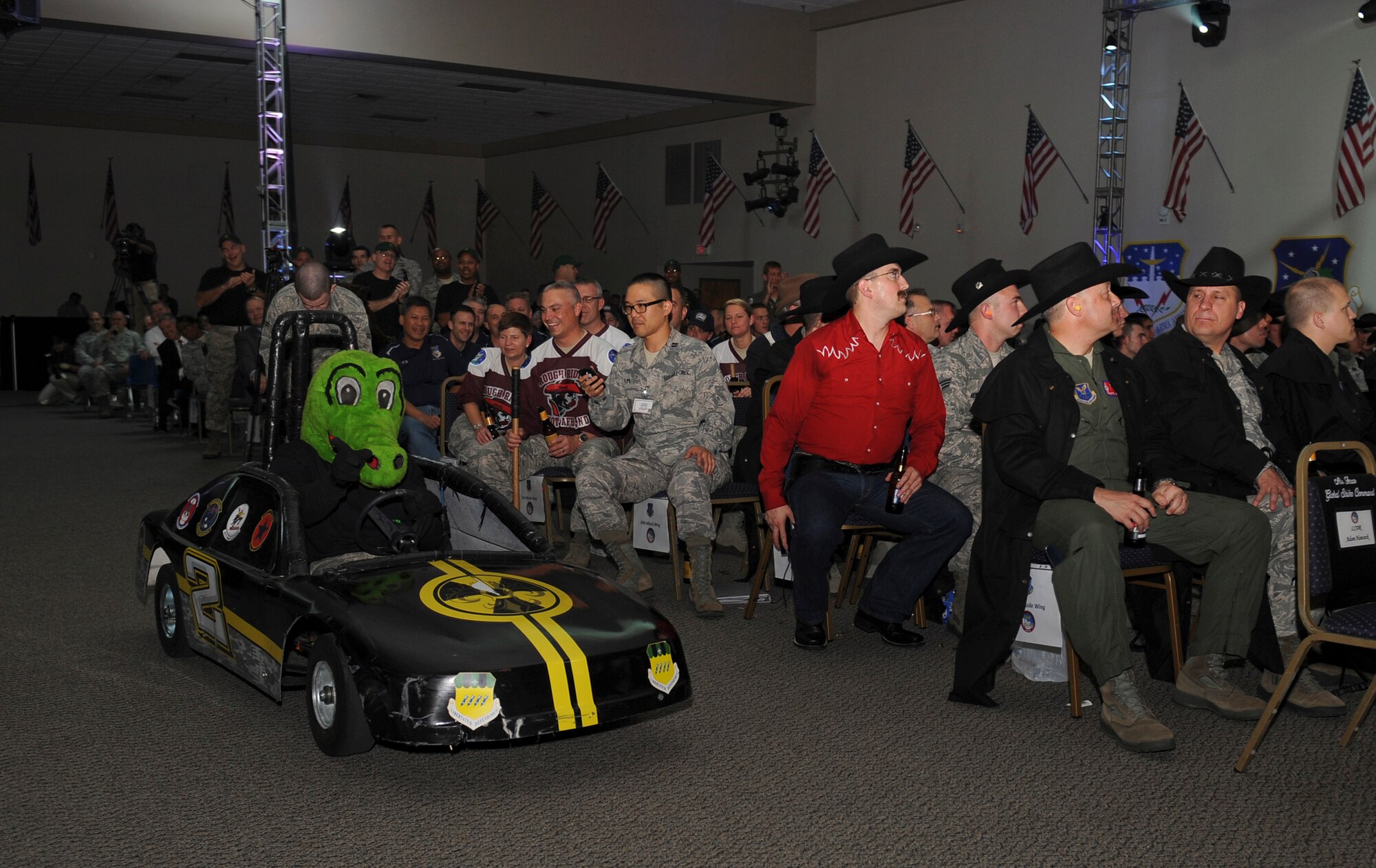 An Airman dressed up as an alligator rides a go-cart as the 2nd Bomb Wing is introduced during the 2012 Air Force Global Strike Challenge score posting at Hoban Hall on Barksdale Air Force Base, La., Nov. 7.  The GSC is an amalgam of the best of the historic bomb competition and the former missile competition held under previous major commands that owned the missile and bomber missions at the time. The challenge is unique when compared to those competitions because it includes operations, maintenance and security forces participants from both the missile and bomber communities under the Air Force Global Strike Command. It also welcomes teams and weapon systems from other major commands. (U.S. Air Force photo/Airman 1st Class Benjamin Gonsier)(RELEASED)
