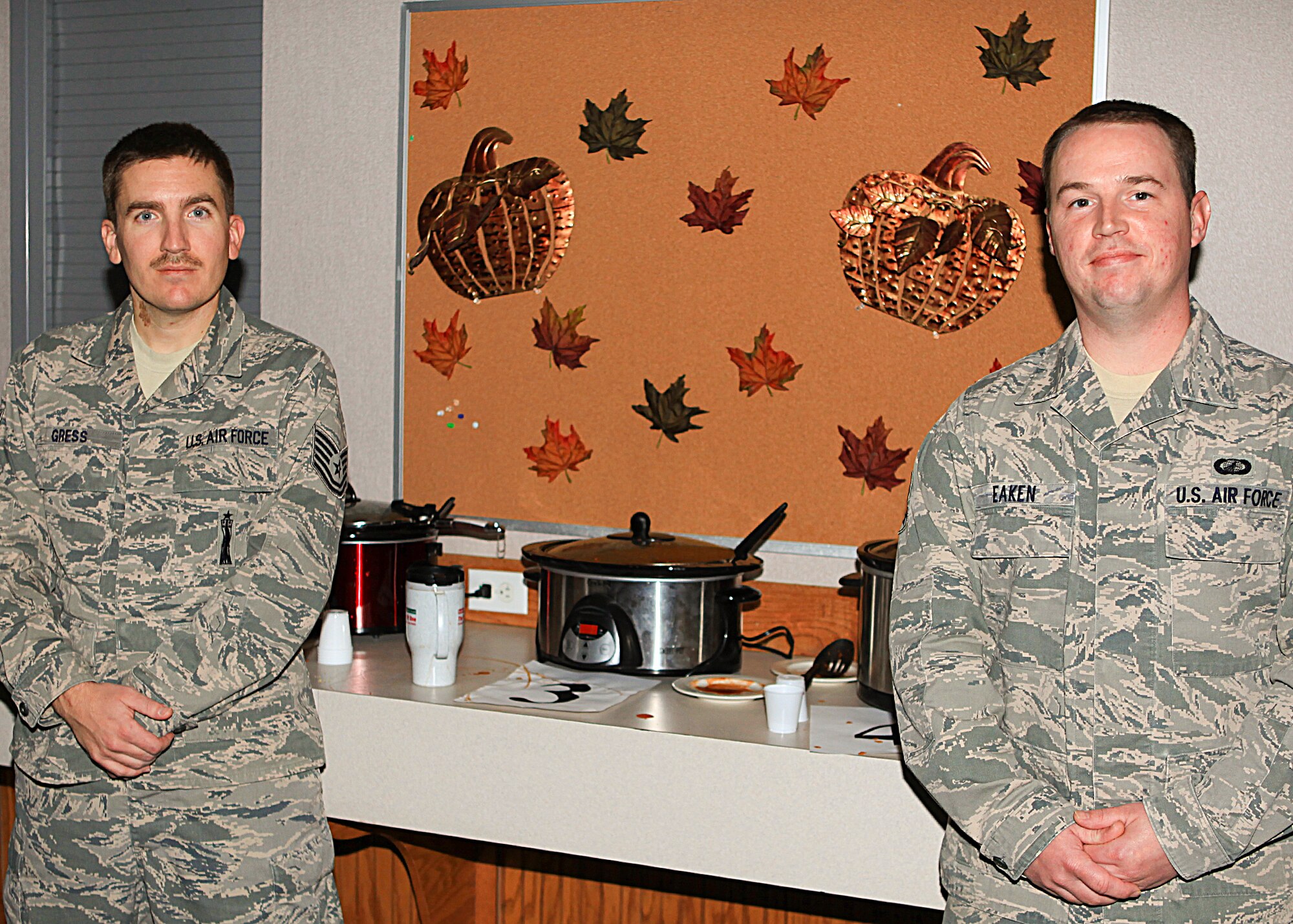 Tech. Sgt. Justin Gress, 90th Missile Maintenance Squadron, and Senior Airman Timothy Eaken, 90th Comptroller Squadron, pose for a photograph during a chili cook-off. The chili cook-off was held Wed. Nov. 7 at the Chapel Activity Center to raise money for the 90th Missile Wing annual awards banquet in February. The chili cook-off helped raise more than $100. (U.S. Air Force photo by Matt Bilden)