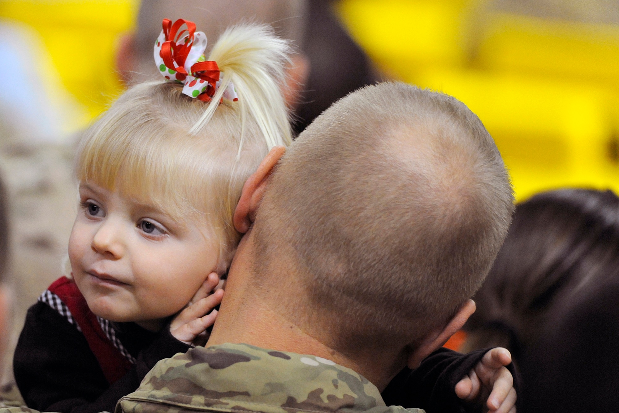 Two--year-old Deanna Ferris takes advantage of an opportunity to enjoy being with her father, Staff Sgt. Kiel Ferris, 4th Brigade Combat Team (Airborne), 25th Infantry Division, during the brigade's redeployment ceremony Nov. 1 at the Sullivan Arena in Anchorage. (U.S. Air Force photo by John Pennell)