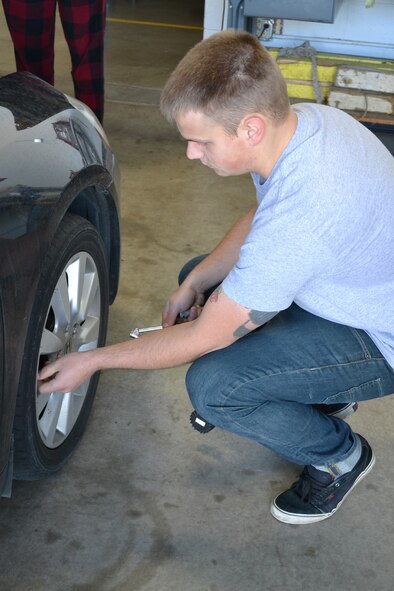 Senior Airman Kurt Stuettgen, 341st LRS mechanic, checks the air pressure of a vehicle during as part of a winter inspection on the car on Nov. 3.  During the vehicle inspections, the mechanics checked lights, fluid levels, batteries, tires and other vehicle items.  (U.S. Air Force photo/Airman 1st Class Cortney Paxton)