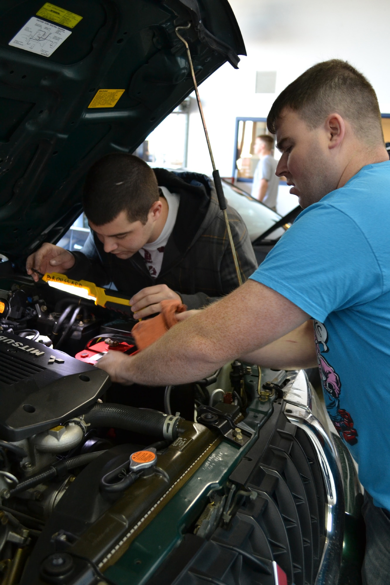 Senior Airman Chris Cagle, right, and Staff Sgt. Shane McDonald, both 341st Logistics Readiness Squadron mechanics, check various systems under the hood of a vehicle for proper functionality.  During the past two weekends, the 341st LRS offered free privately owned vehicle inspections for members of Team Malmstrom to ensure their vehicles are prepared for winter.  (U.S. Air Force photo/Airman 1st Class Cortney Paxton)