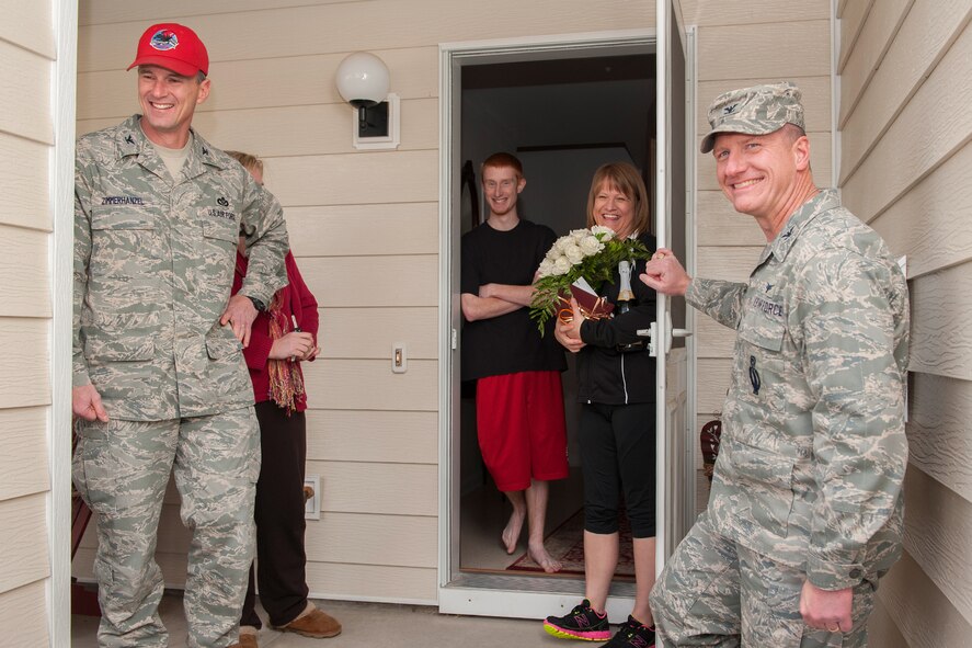 Col. Mark Zimmerhanzel, 819th RED HORSE Squadron, far left, and Col. Robert Stanley, 341st Missile Wing vice commander, smile for a photo with the Jones family after telling them of Senior Master Sgt. Joel Jones’, 819th RHS superintendent of engineering, selection for promotion to chief master sergeant.  Joel’s son, Josh, and wife, Melanie, accepted the presentation on his behalf while he is currently deployed.  (U.S. Air Force photo/Beau Wade)
