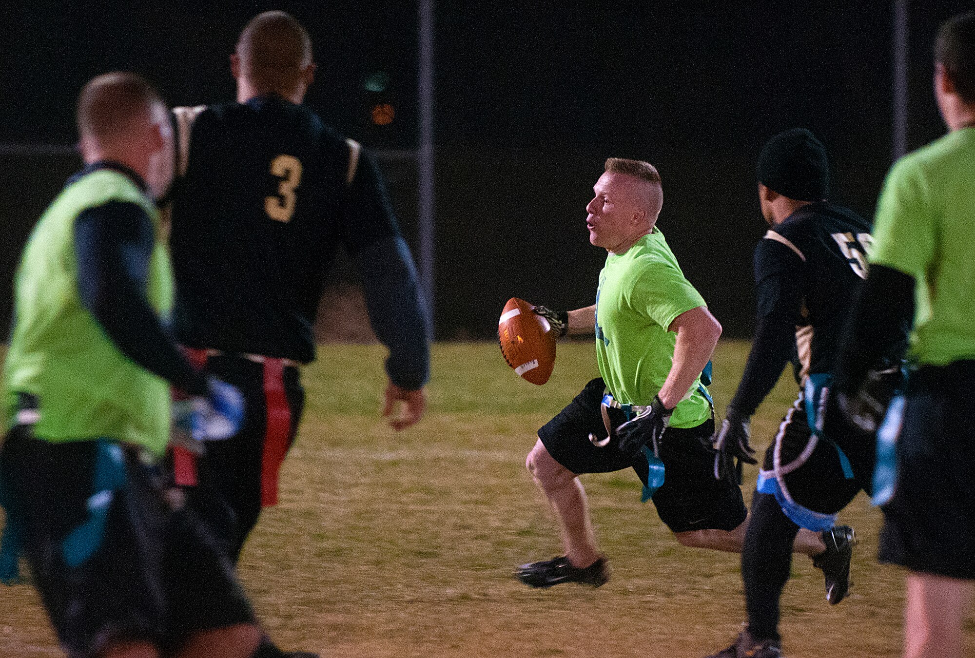 Quarterback Staff Sgt. Andrew Vautrin, 90th Security Support Squadron NCO who was a 90th Security Forces Group Tactical Response Force member at the beginning of the flag football season, sprints for yardage against the 90th Maintenance Group in the second half of the F. E. Warren flag football championship game Nov. 2. The 90th SFG/TRF went on to win the game 19 to 13 to claim the title. (U.S. Air Force photo by R.J. Oriez)