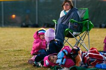 Fans of the 90th Security Forces Group Tactical Response Force flag football team stay warm on the sidelines of the F. E. Warren flag football championship games Nov. 2. Their attendance paid off as the 90th SFG/TRF won the title. (U.S. Air Force photo by R.J. Oriez)